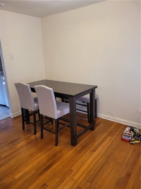 dining space with wood-type flooring