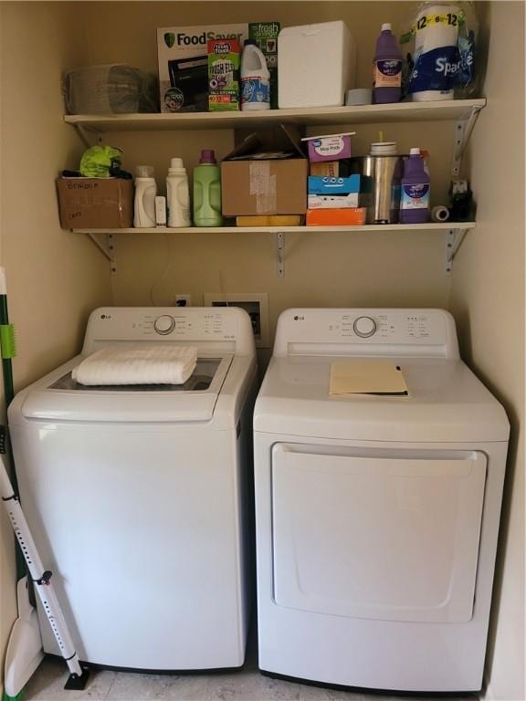 clothes washing area with washing machine and dryer