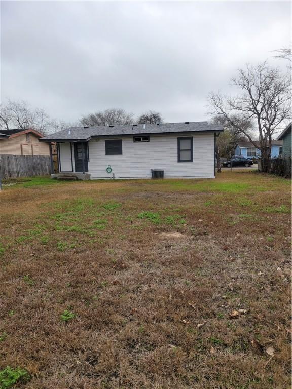 back of house featuring a yard and central AC unit