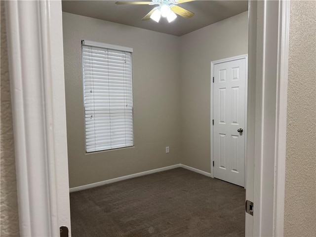 carpeted empty room featuring ceiling fan