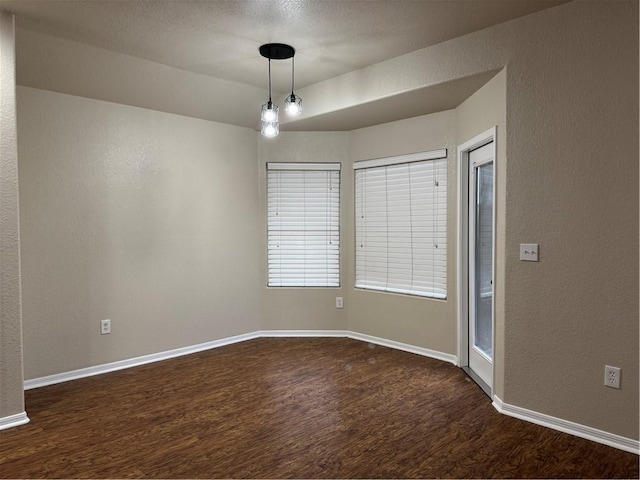 unfurnished room featuring dark hardwood / wood-style flooring