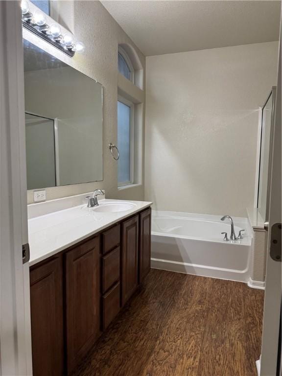 bathroom featuring separate shower and tub, vanity, and hardwood / wood-style floors