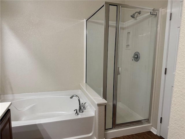 bathroom featuring vanity, hardwood / wood-style floors, and shower with separate bathtub