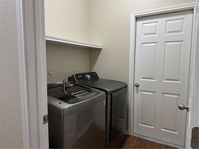 clothes washing area featuring washer and dryer and dark hardwood / wood-style floors