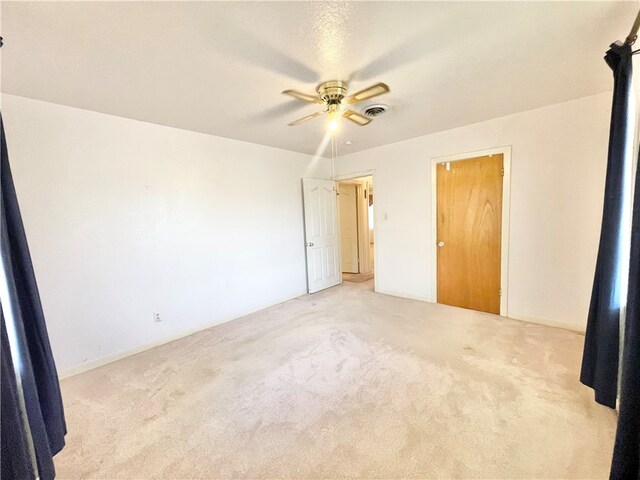 unfurnished bedroom with ceiling fan and light carpet