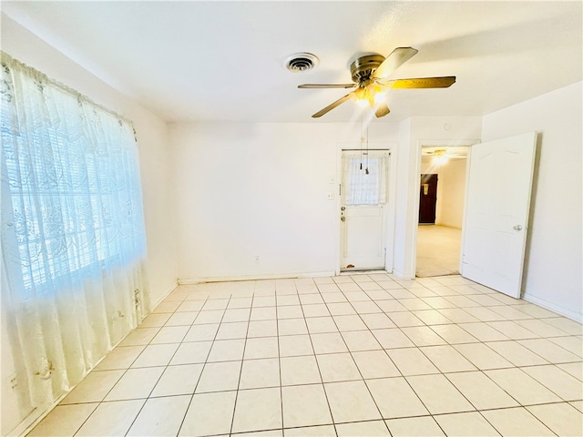 unfurnished room featuring ceiling fan and light tile patterned flooring