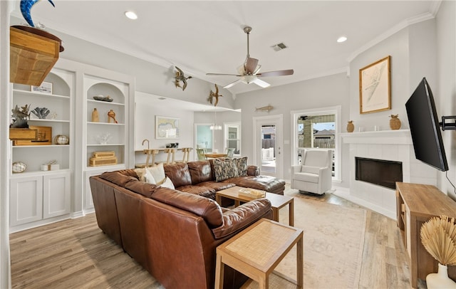15822 Portillo Dr, Corpus Christi, TX 78418 - living room with light wood-style flooring, ornamental molding, a ceiling fan, a fireplace, and recessed lighting