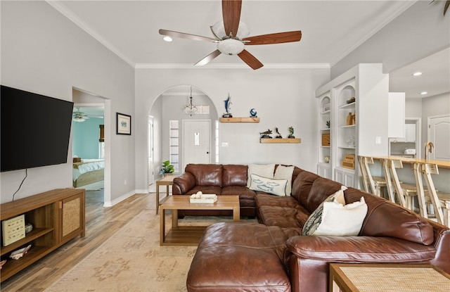 15822 Portillo Dr, Corpus Christi, TX 78418 - living area with ceiling fan, arched walkways, light wood finished floors, ornamental molding, and recessed lighting