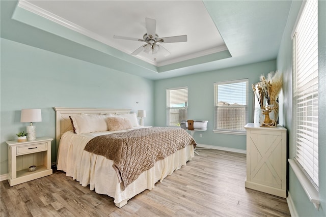 15822 Portillo Dr, Corpus Christi, TX 78418 - bedroom featuring a tray ceiling, light wood-type flooring, crown molding, and ceiling fan