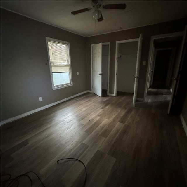 unfurnished bedroom with dark hardwood / wood-style floors and ceiling fan