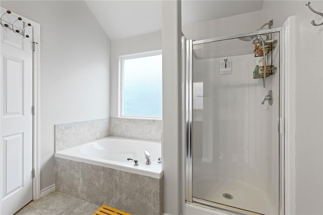 bathroom with lofted ceiling, tile patterned floors, and independent shower and bath