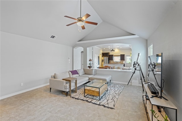 living room with light tile patterned floors, high vaulted ceiling, and ceiling fan