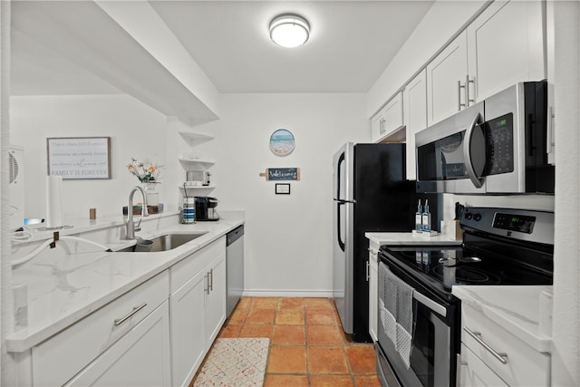 kitchen with white cabinetry, sink, light stone counters, and appliances with stainless steel finishes