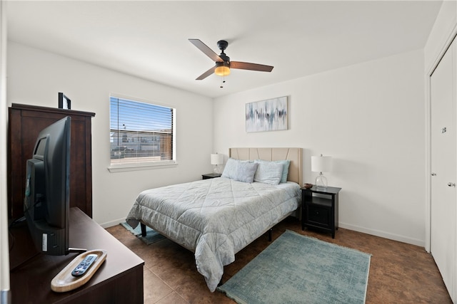 bedroom featuring dark tile patterned flooring and ceiling fan