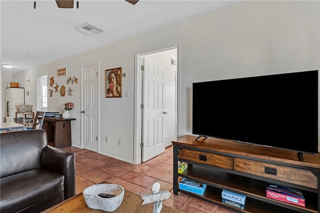 tiled living room with ceiling fan