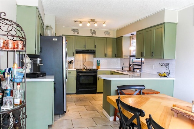 5306 Crestwick Dr, Corpus Christi, TX 78413 - kitchen featuring green cabinets, electric range, under cabinet range hood, a peninsula, and backsplash