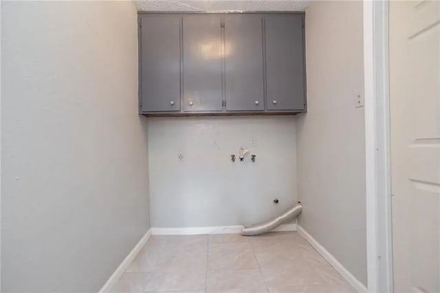 5306 Crestwick Dr, Corpus Christi, TX 78413 - laundry room featuring electric dryer hookup, cabinet space, light tile patterned floors, and hookup for a washing machine