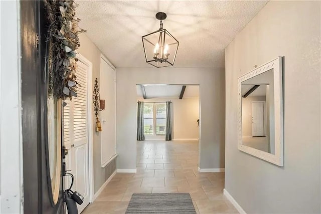 5306 Crestwick Dr, Corpus Christi, TX 78413 - corridor featuring a textured ceiling, a chandelier, and light tile patterned floors