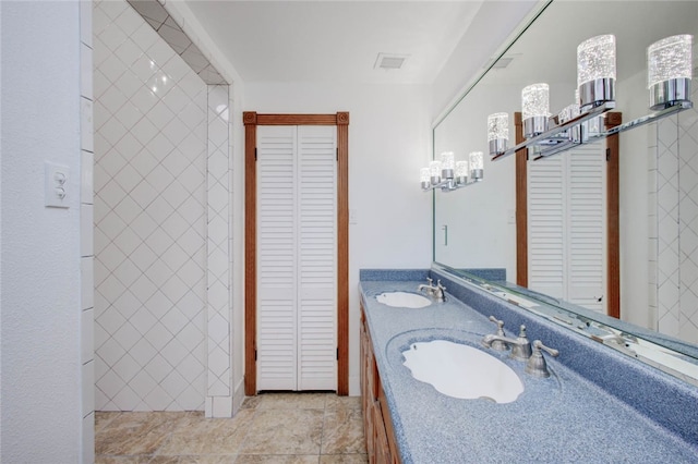 bathroom with tile patterned flooring and vanity