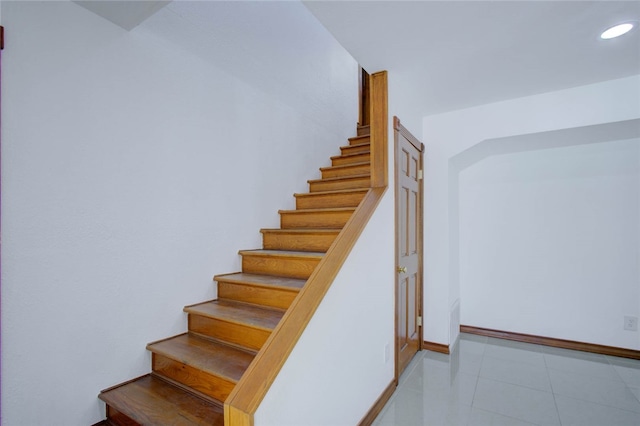 stairway featuring tile patterned floors