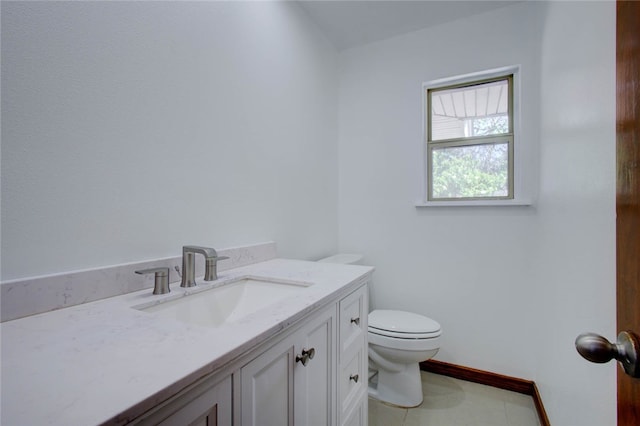 bathroom featuring vanity, tile patterned floors, and toilet