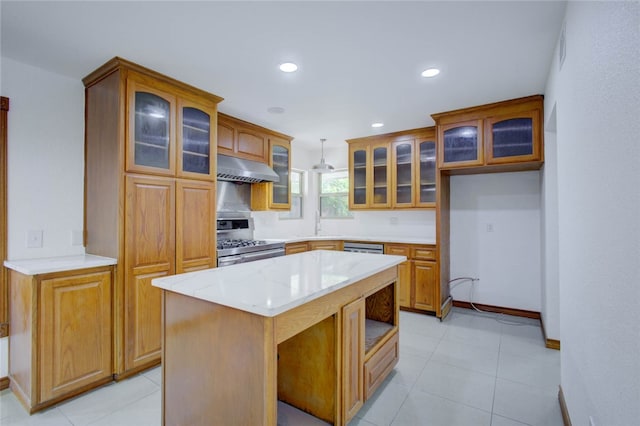 kitchen featuring light stone counters, light tile patterned floors, a kitchen island, stainless steel stove, and pendant lighting