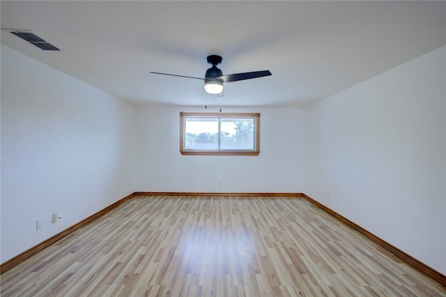 empty room with light hardwood / wood-style flooring and ceiling fan