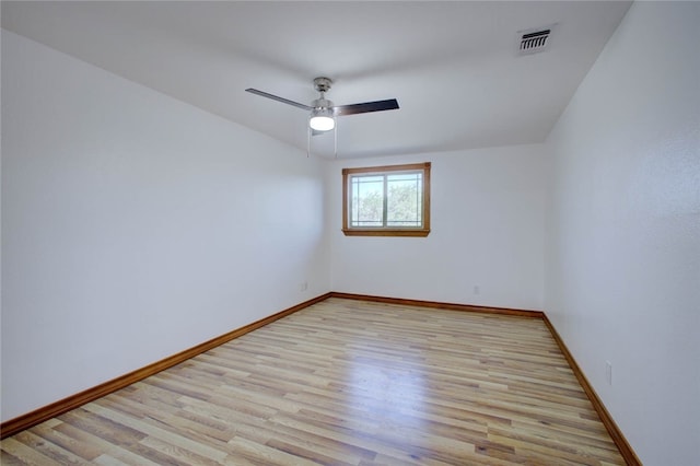 empty room with ceiling fan and light hardwood / wood-style floors