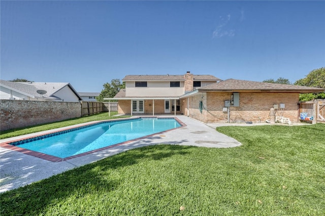 view of swimming pool featuring a patio area and a lawn