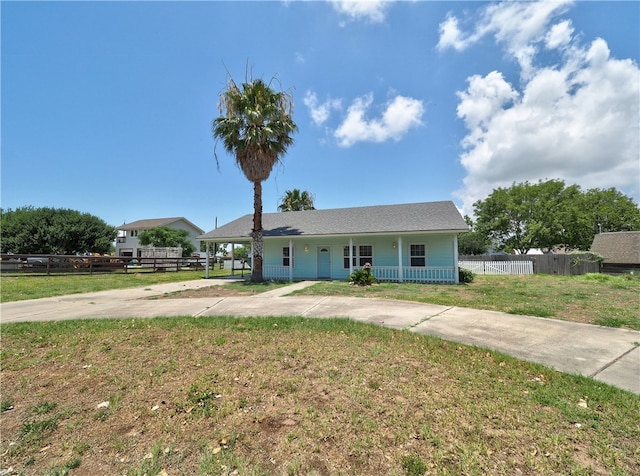 ranch-style house with a porch and a front yard