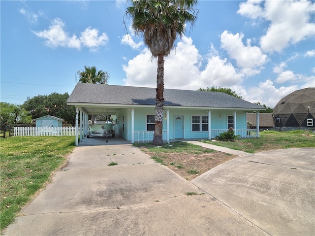 view of front facade with a carport, covered porch, and a front yard