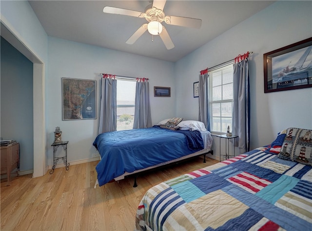 bedroom with ceiling fan and light hardwood / wood-style flooring