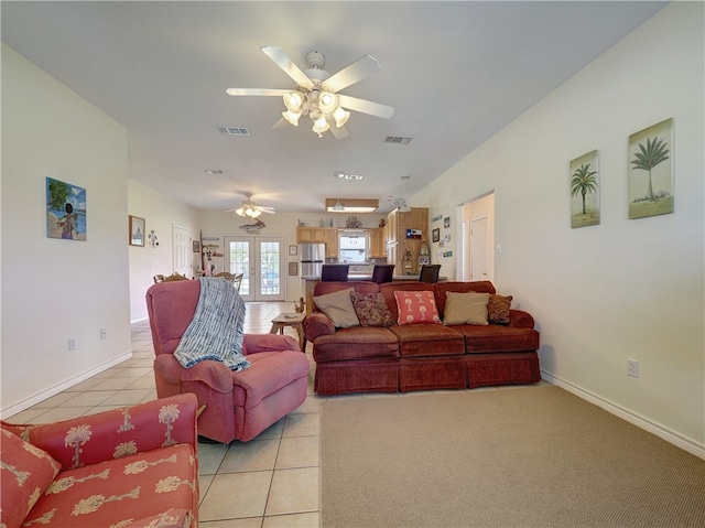 tiled living room featuring french doors and ceiling fan