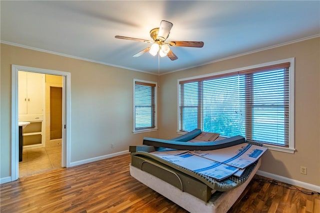 bedroom featuring ceiling fan, hardwood / wood-style floors, and crown molding