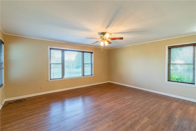 unfurnished room featuring dark hardwood / wood-style flooring, a healthy amount of sunlight, and ornamental molding