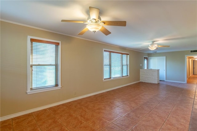 tiled empty room featuring ceiling fan, a healthy amount of sunlight, and crown molding