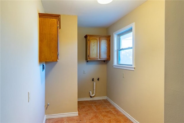 laundry room featuring gas dryer hookup, light tile patterned floors, cabinets, and washer hookup