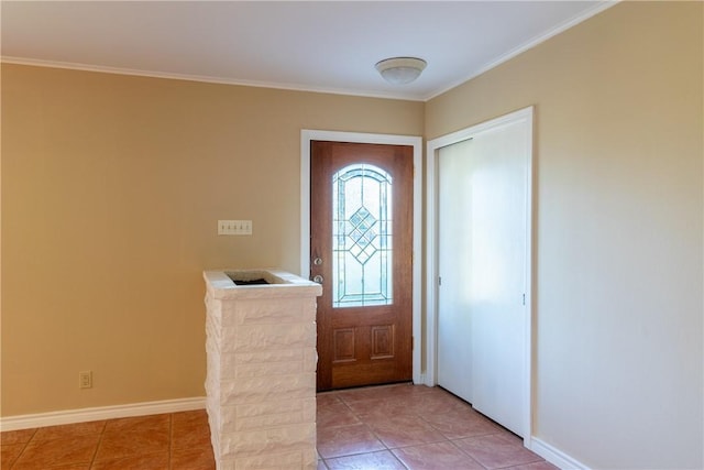 entrance foyer featuring light tile patterned floors and ornamental molding