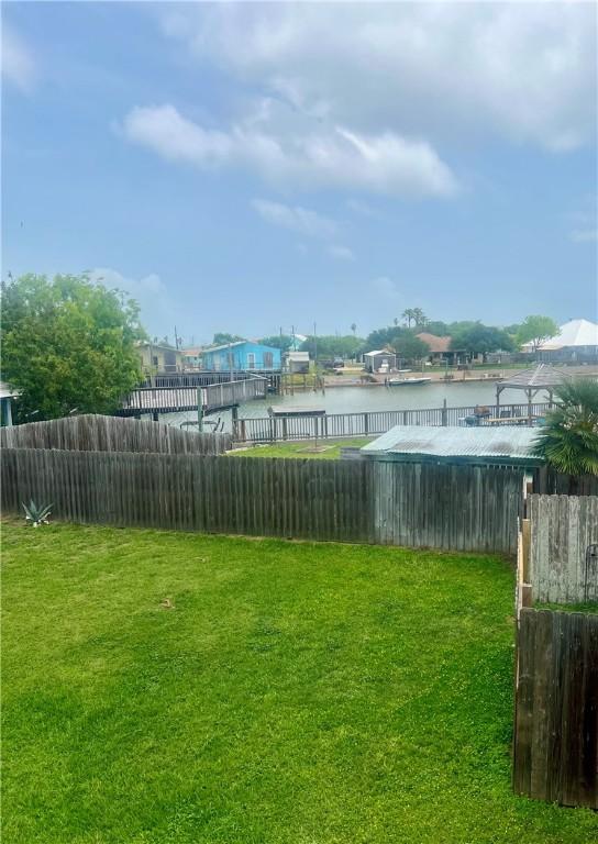 4141 Whiteley Dr Unit 404, Corpus Christi, TX 78418 - view of yard with a water view and fence