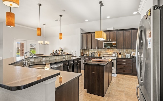 7502 Stampede Dr, Corpus Christi, TX 78414 - kitchen featuring appliances with stainless steel finishes, a large island with sink, backsplash, dark brown cabinets, and recessed lighting