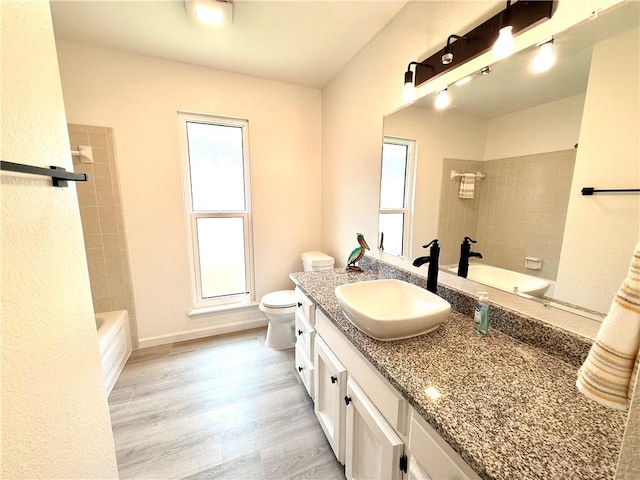 4126 Crenshaw Dr, Corpus Christi, TX 78413 - bathroom with vanity, wood finished floors, and shower / bathtub combination
