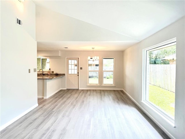 4126 Crenshaw Dr, Corpus Christi, TX 78413 - unfurnished living room featuring lofted ceiling, wood finished floors, and a chandelier