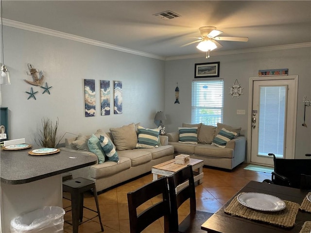 tiled living room featuring ceiling fan and crown molding