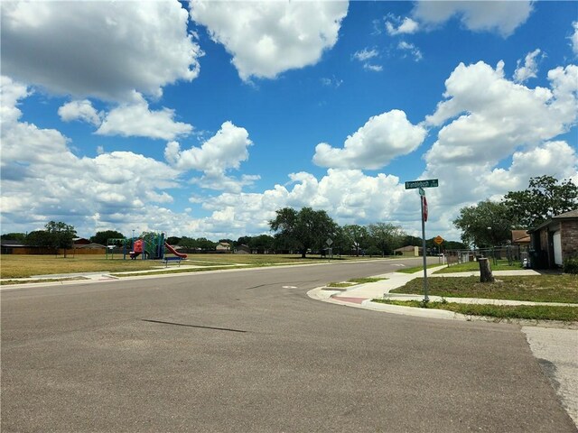 2742 Bramblebush Dr, Corpus Christi, TX 78410 - view of asphalt road featuring sidewalks, curbs, and traffic signs