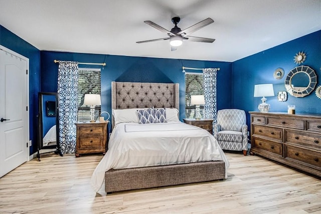 bedroom with light wood-style flooring and ceiling fan