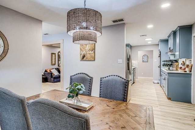 dining space with baseboards, visible vents, parquet floors, a notable chandelier, and recessed lighting