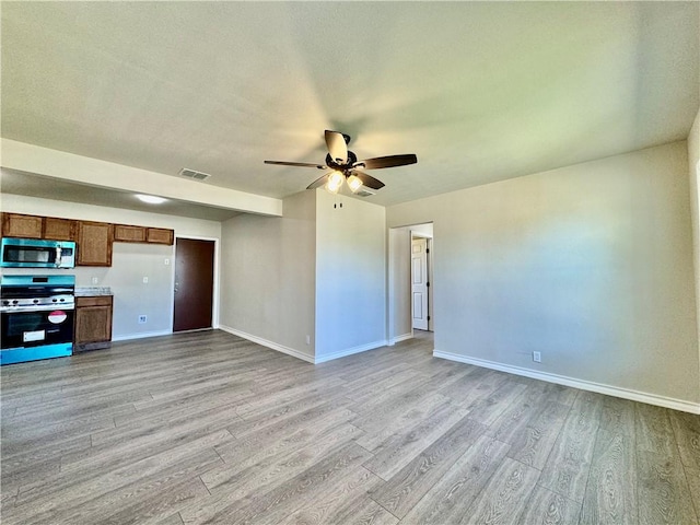 unfurnished living room with ceiling fan and light wood-type flooring