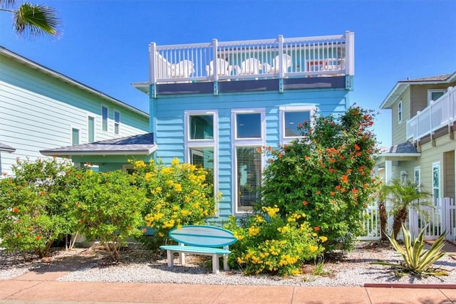 back of property with a balcony
