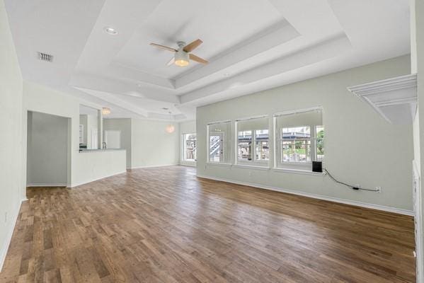 14154 Cutlass Ave, Corpus Christi, TX 78418 - unfurnished living room featuring a raised ceiling, a ceiling fan, and wood finished floors
