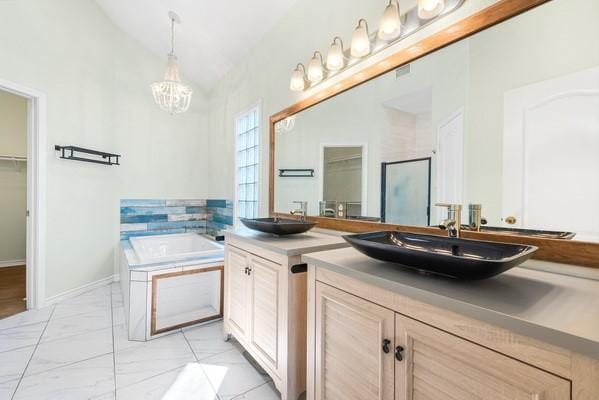 14154 Cutlass Ave, Corpus Christi, TX 78418 - bathroom featuring vaulted ceiling, vanity, a walk in closet, a bath, and a shower stall